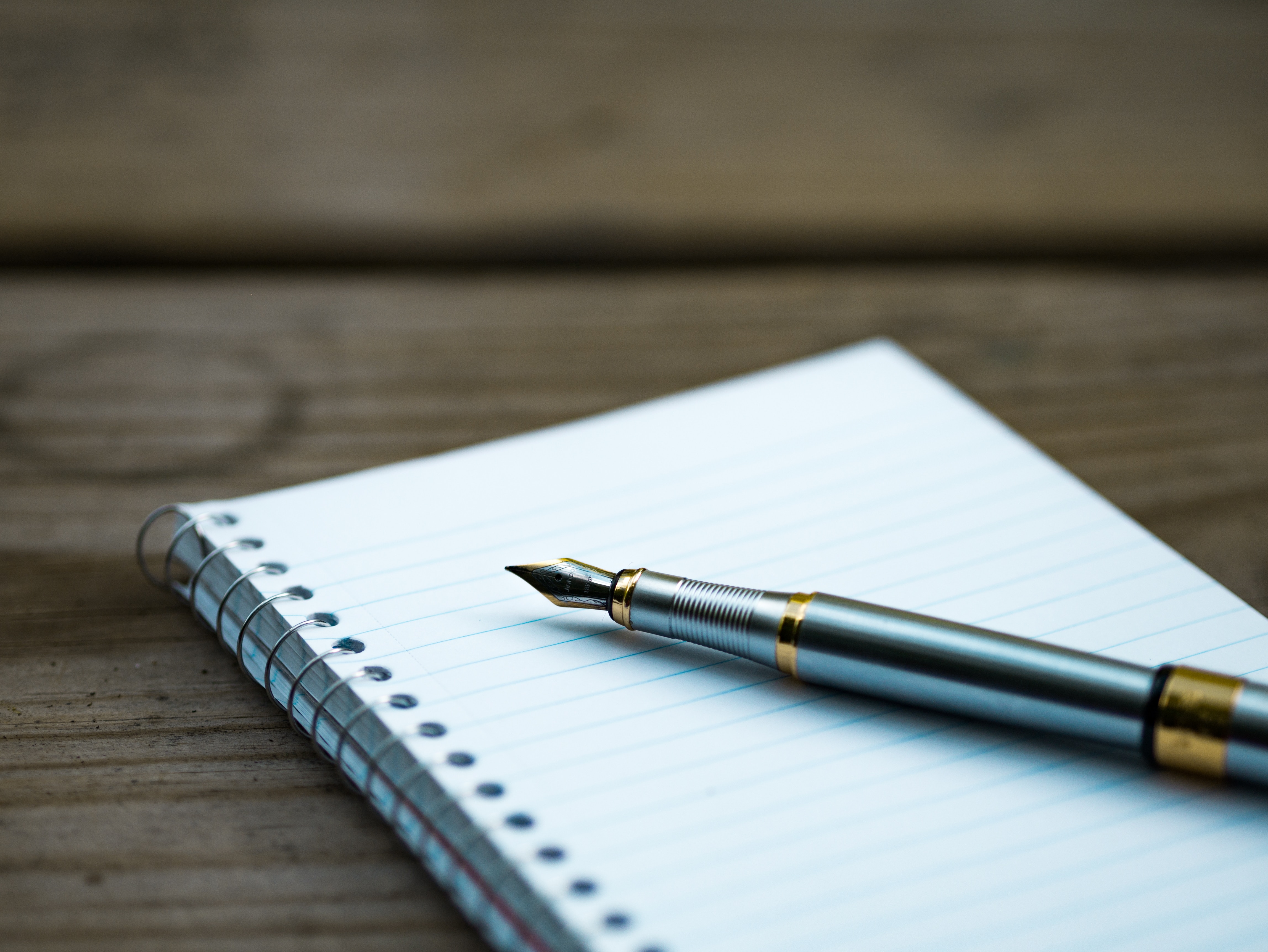 fountain pen resting on notebook